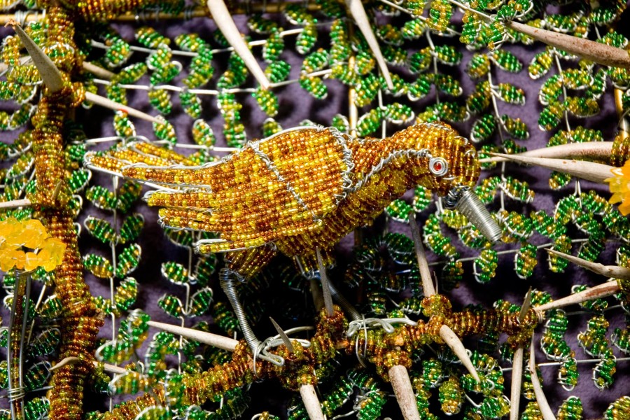 Wire beadwork depicting local animals and a flower in the third layer of the Keiskamma Altarpiece