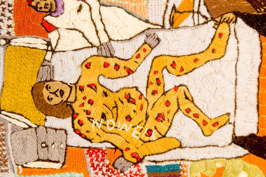 Embroidered predella figure with red spots representing advanced illness