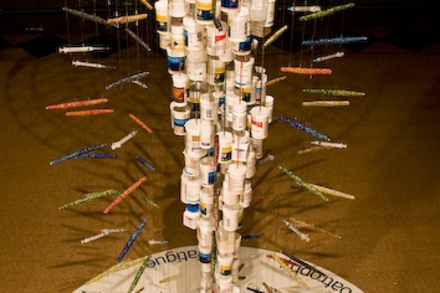 A version of *Medicine Man* suspended above a circular base labeled with medication side effects