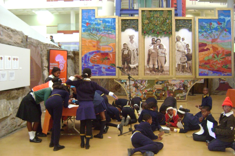 Young visitors in school uniforms viewing the *Keiskamma Altarpiece*