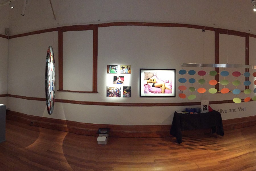 Panoramic view of multiple works displayed in a gallery