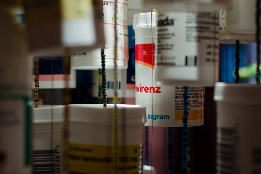 Suspended HIV medication bottles in Daniel Goldstein’s *Medicine Man*