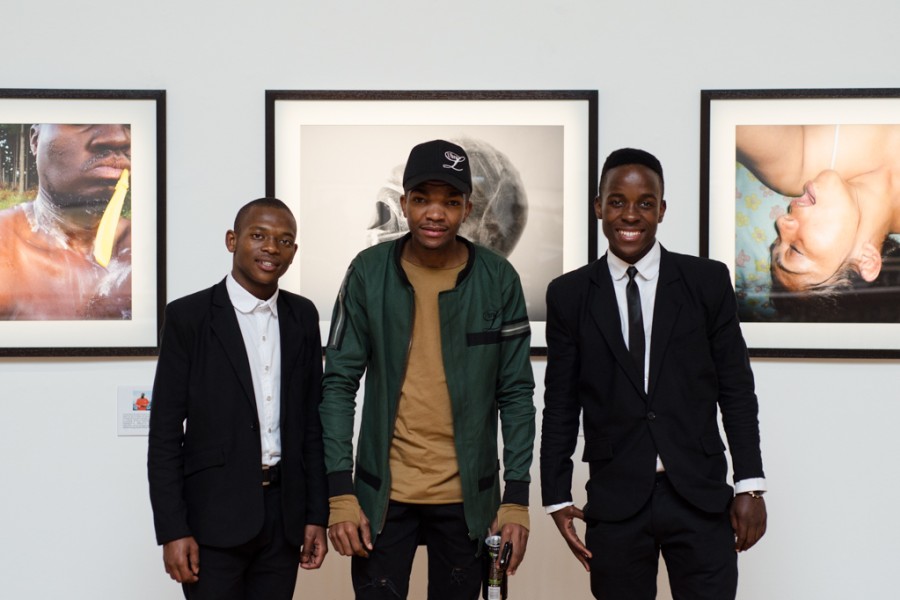 Three people gathered at the exhibition opening