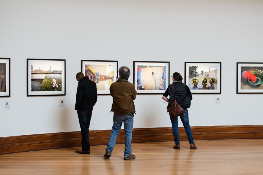 Visitors viewing photographs in the My Photo. My Story. section during the exhibition opening