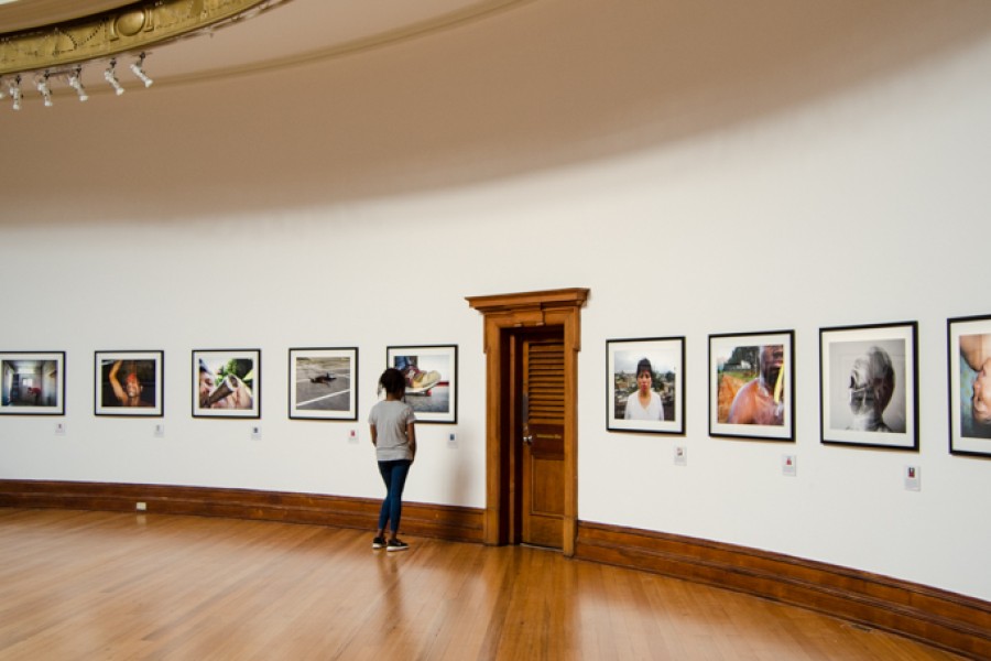 A visitor viewing photographs along the central gallery’s curving wall