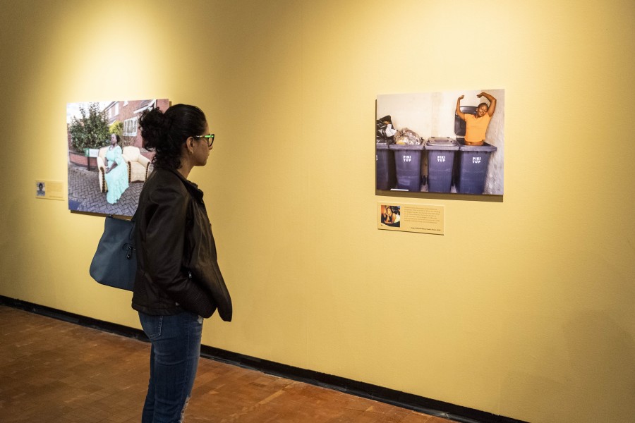 Person viewing photographs and stories by Through Positive Eyes artivists