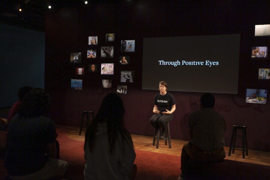 Kelly storytelling before an audience in the Banishing Stigma Room