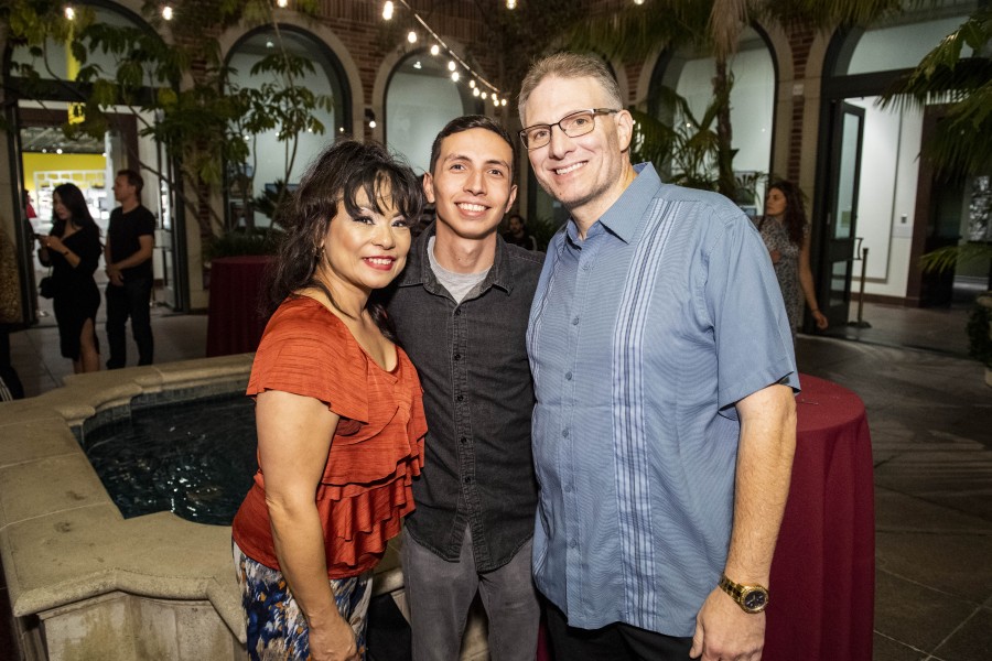 Isaiah Baiseri posing with his parents at the exhibition opening