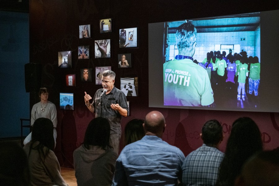 Joey storytelling with his photograph displayed behind him