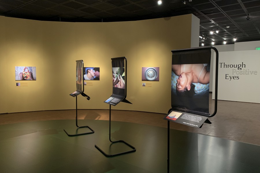 Row of photographs by Through Positive Eyes artivists in the gallery
