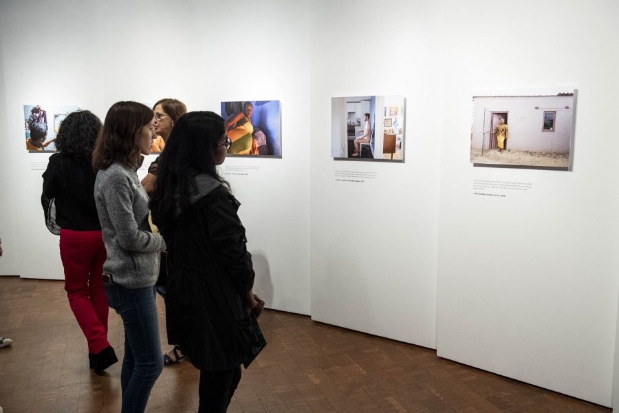 People viewing photographs and stories by Through Positive Eyes artivists