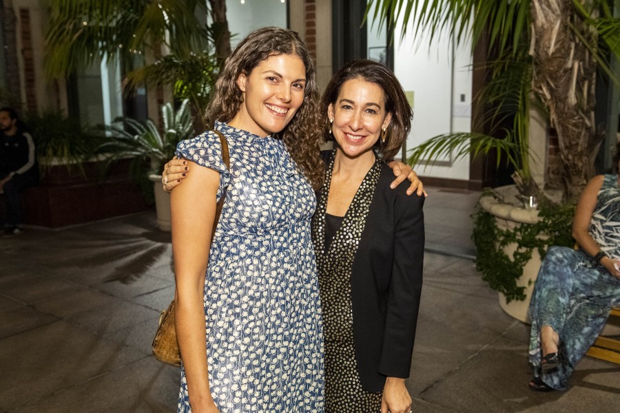 UCLA Art & Global Health Center staff member posing with a Fowler Museum staff member at the exhibition opening