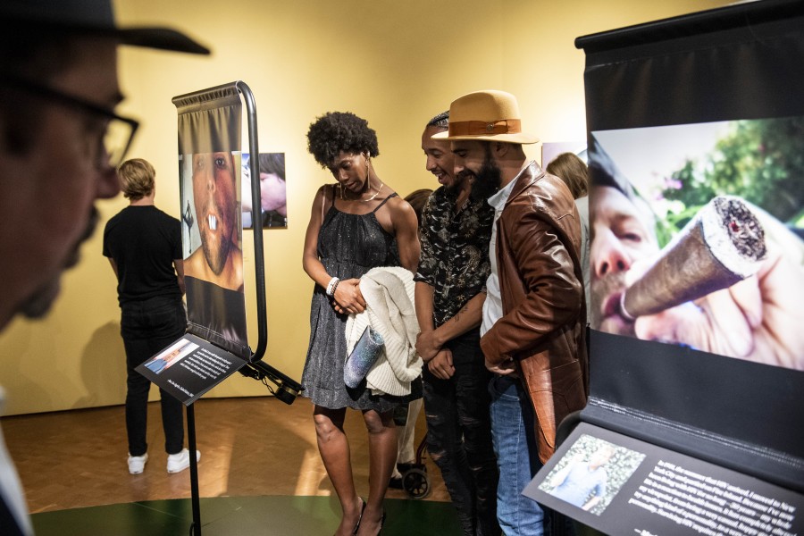 People viewing photographs and stories by Through Positive Eyes artivists