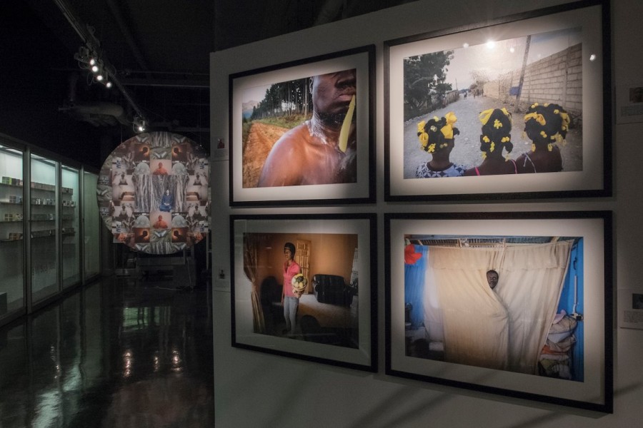 Gallery view with works displayed alongside framed photographs