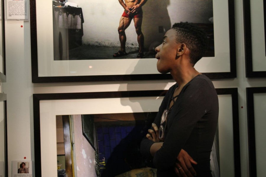 A visitor viewing a photograph by a Through Positive Eyes artivist