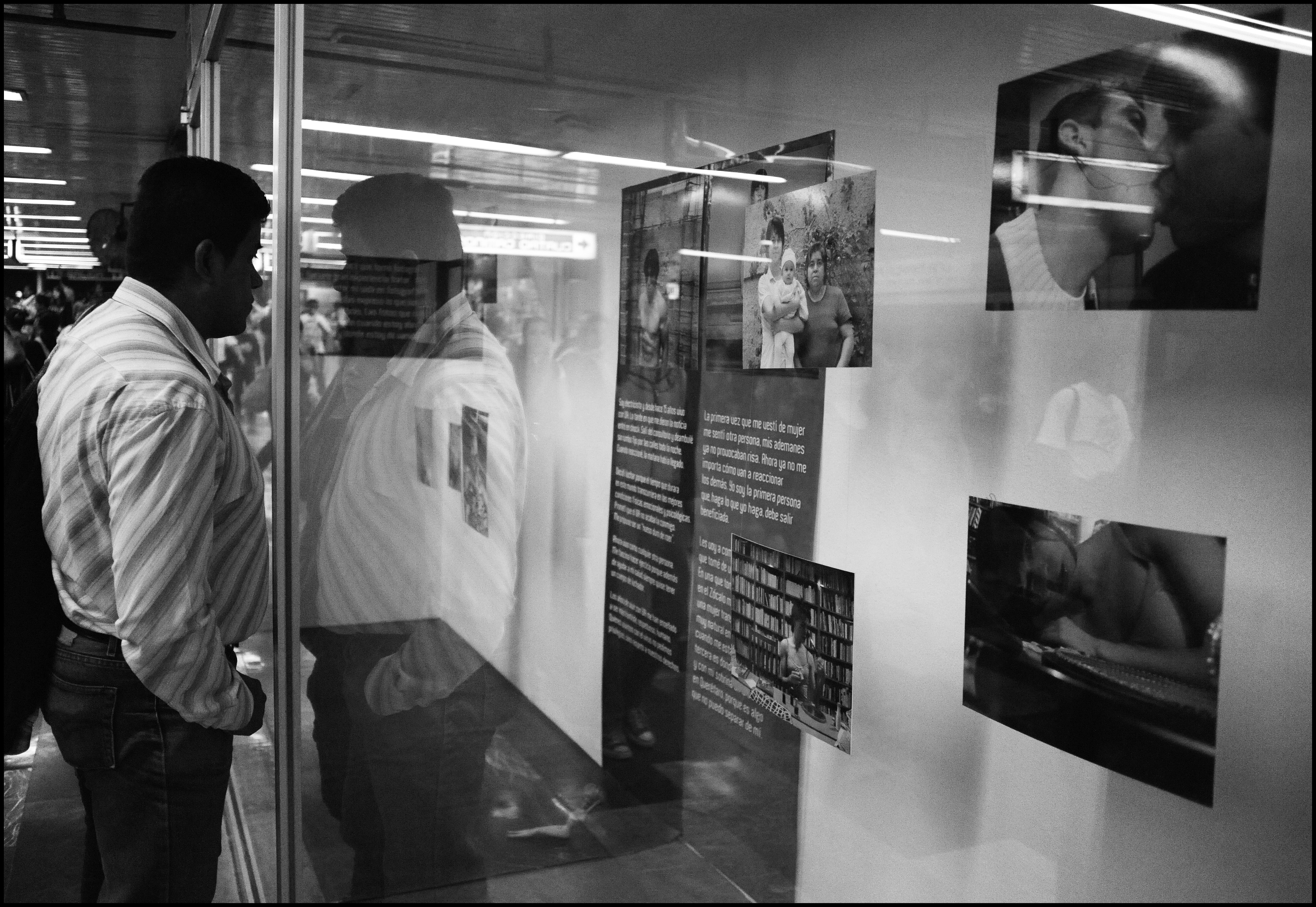 A person viewing photographs and stories by Through Positive Eyes artivists